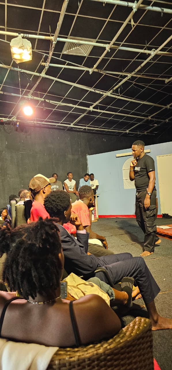 Gibendi speaking with creatives during a theatre production