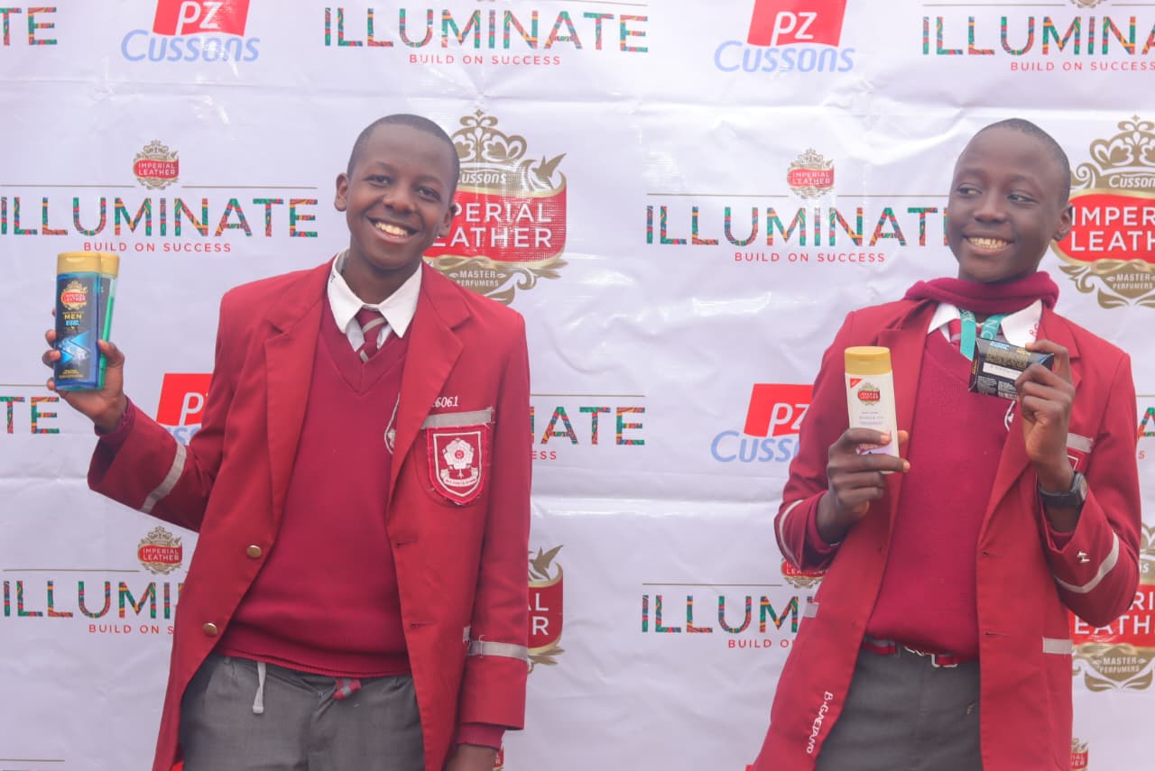 Illuminate students holding Imperial Leather products at a school event